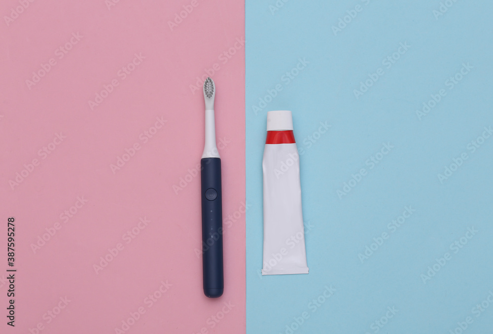 Dental care. Tube of toothpaste with toothbrush on blue pink background. Dental care. Tube of toothpaste with toothbrush on blue pink background.