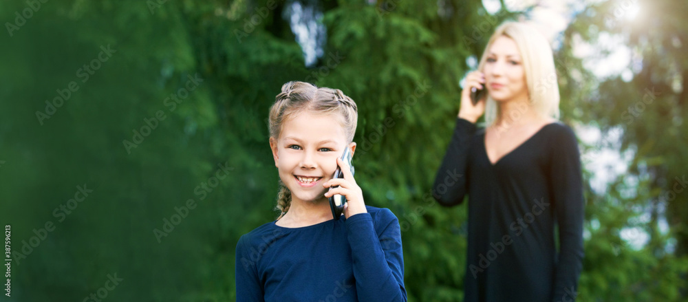 Mother and little daughter. Phone conversation. Happy family portrait ...