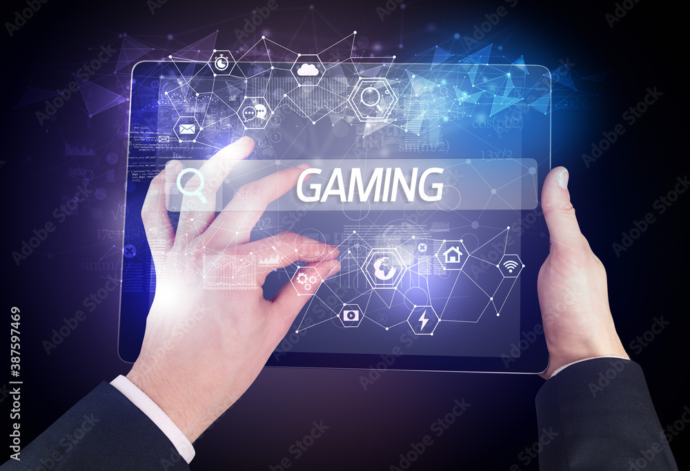 Close-up of a tablet searching GAMING inscription, hi-tech computing concept Close-up of a tablet searching GAMING inscription, hi-tech computing concept