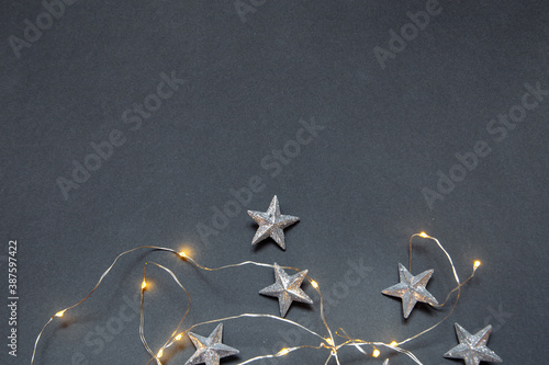 New Year s gray photophone with Christmas garland and stars