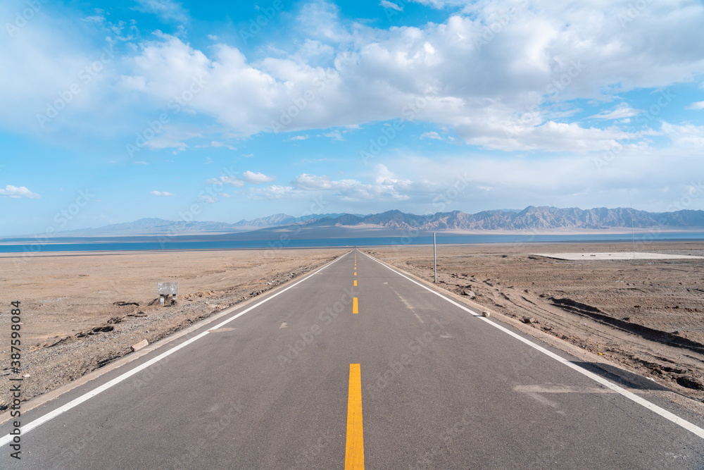 road in the desert to the lake 