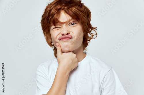 emotional redhead boy cropped view grimace gray