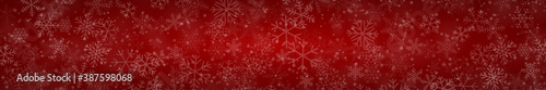 Christmas banner of snowflakes of different shapes  sizes and transparency on red background