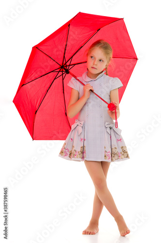 Little girl under an umbrella.Concept style and fashion. Isolated on white background.