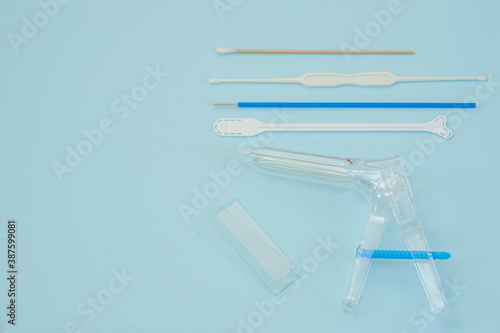 Medical banner gynecological set for vaginal examination of a woman on a blue background with place for text. Women's health concept