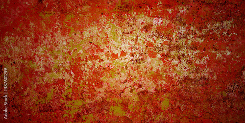 Ancient wall with peeling plaster. Old concrete wall, panoramic with red golden blotches textured background, vignette
