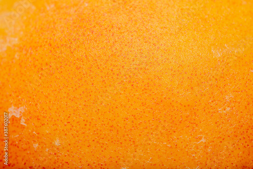 Background with close-up of nectarine surface in soft focus