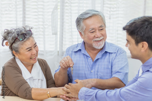 Happy retired Asian senior eldery couple hands shaking business deal and agreement with personal financial advisor or real estate agent. Retirement investment planning with professional counseling.
