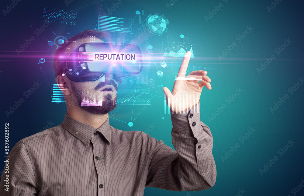 Businessman looking through Virtual Reality glasses with REPUTATION inscription, new business concept Businessman looking through Virtual Reality glasses with REPUTATION inscription, new business concept