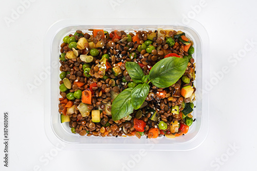 Buckwheat with corn and vegetables in a lunch box. Healthy lunch to go