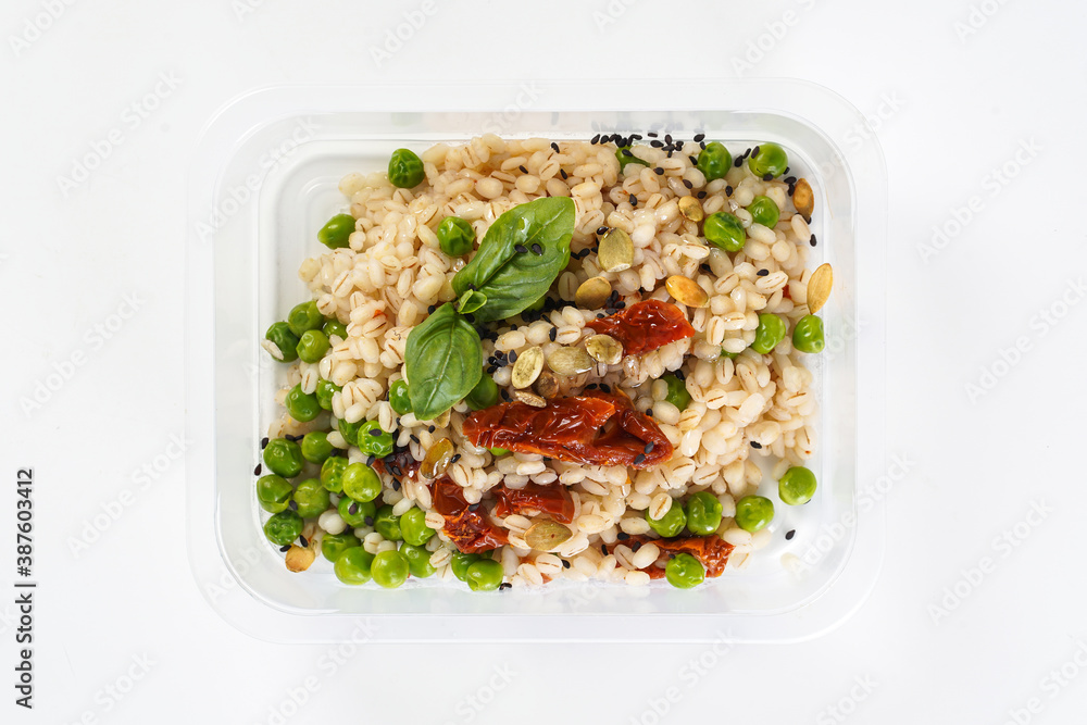 Perlovka with vegetables in a lunch box. Healthy lunch to go Perlovka with vegetables in a lunch box. Healthy lunch to go