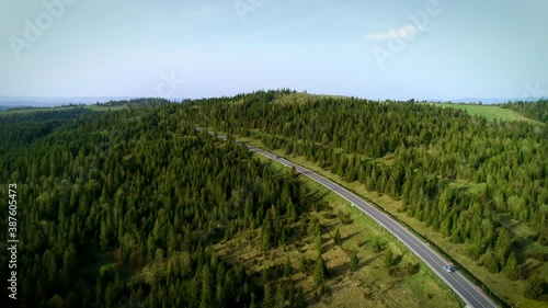 Mountain road. Spring. Route no H13 Ukraine. Coniferous forest in Europe. 
Aerial view of evening sunset. Travel on vacation photo