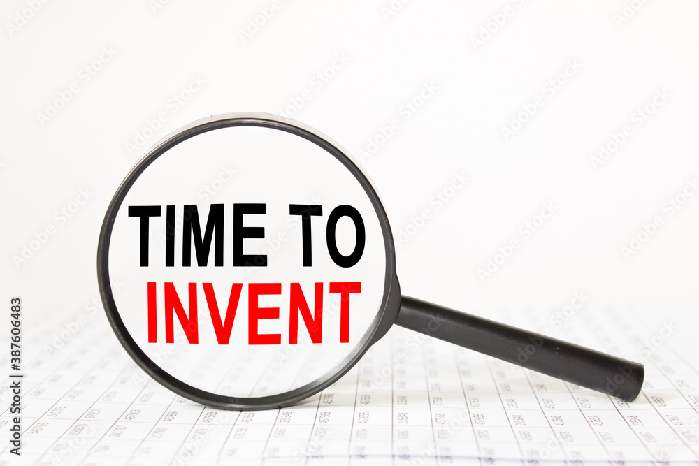 text TIME TI INVENT in a magnifying glass, office concept, business concept, Finance text TIME TI INVENT in a magnifying glass, office concept, business concept, Finance