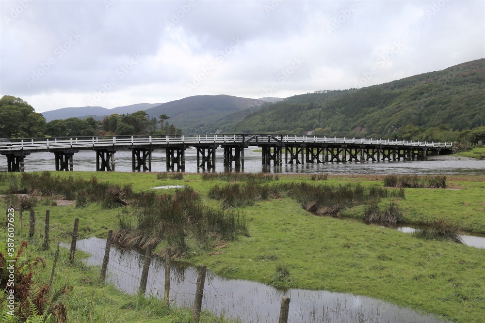 The historical wooden bridge across the Mawddach River at Penmaenpool, Gwynedd, Wales, UK.