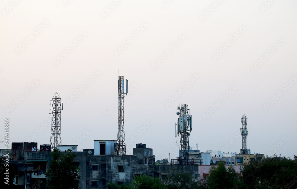 Four telecommunication tower on top of building terrace