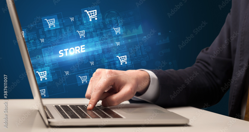 Businessman working on laptop with STORE inscription, online shopping concept Businessman working on laptop with STORE inscription, online shopping concept