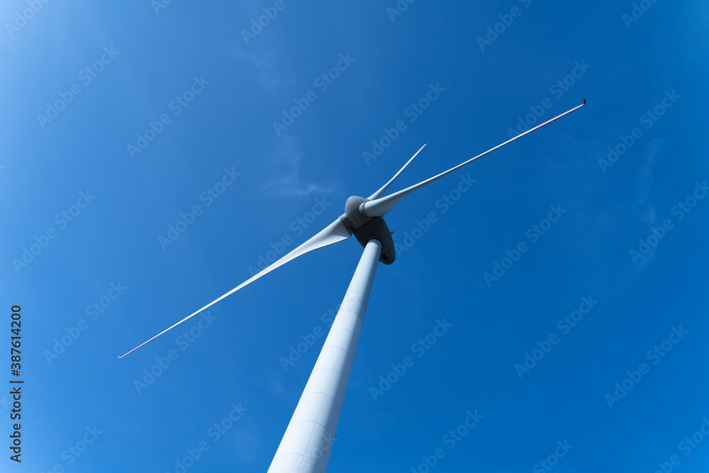 Aerial view large group of eco system wind turbines power generation station on green field in rural landscape in countryside Aerial view large group of eco system wind turbines power generation station on green field in rural landscape in countryside