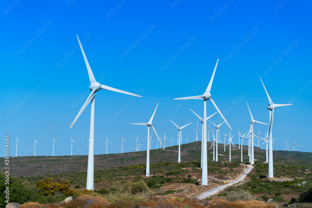 Aerial view large group of eco system wind turbines power generation station on green field in rural landscape in countryside Aerial view large group of eco system wind turbines power generation station on green field in rural landscape in countryside