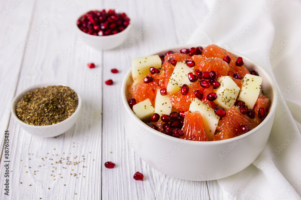 Fresh fruit salad in bowl on wooden table. Concept healthy food, diet, vegan Fresh fruit salad in bowl on wooden table. Concept healthy food, diet, vegan