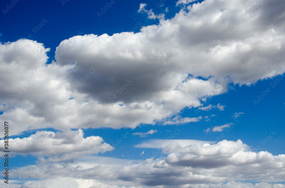 Obraz premium White clouds on a blue sky. Background.