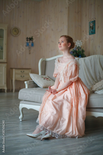 beautiful red-haired girl in vintage dress