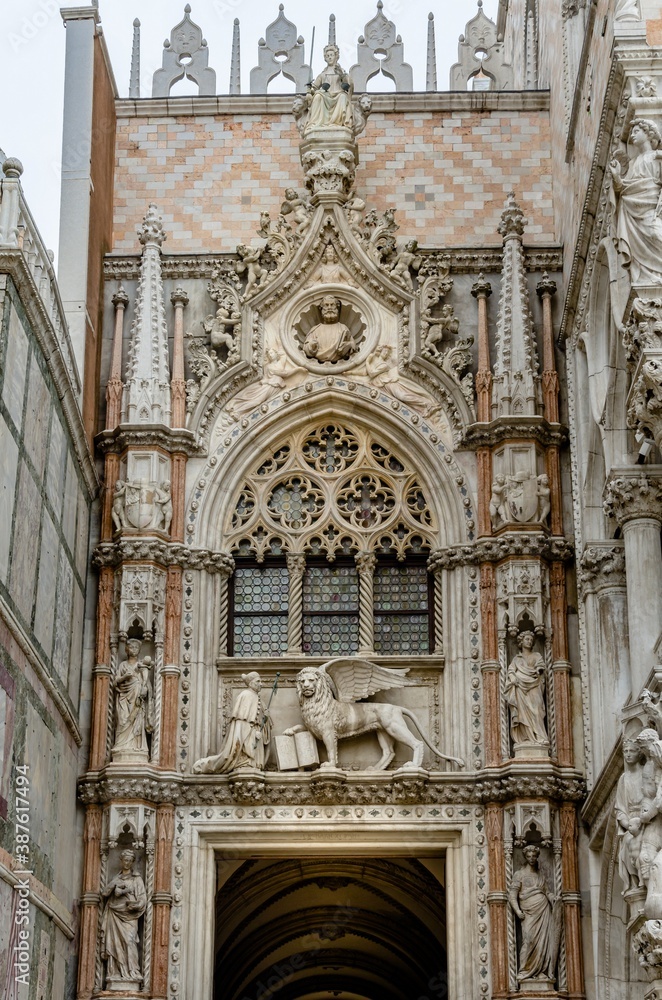 Porta della Carta of the Doges Palace. Doge Francesco Foscari in front of the winged lion (symbol of the Venetian Republic). Arch with decorative elements in Gothic style. Venice. Italy
