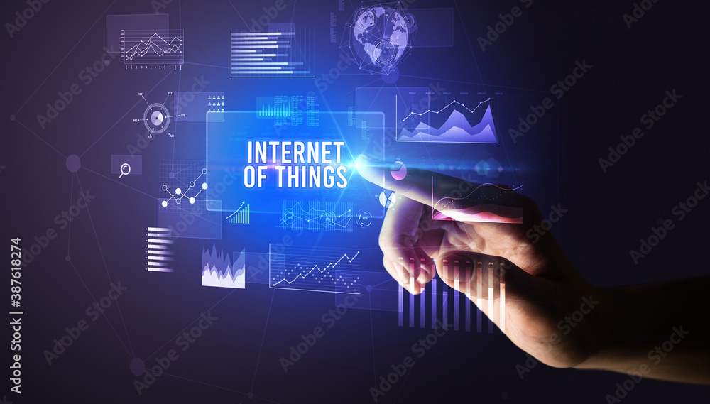 Hand touching INTERNET OF THINGS inscription, new business technology concept Hand touching INTERNET OF THINGS inscription, new business technology concept