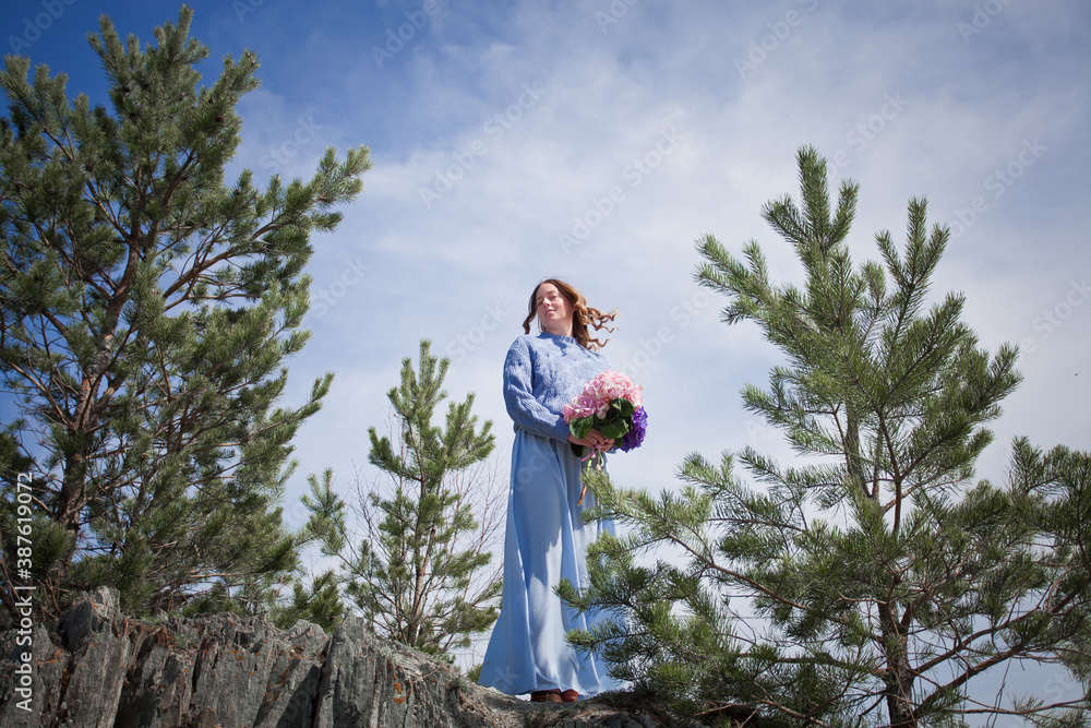 girl with a bouquet of hydrangeas walks on the shore, spring photo session girl with a bouquet of hydrangeas walks on the shore, spring photo session