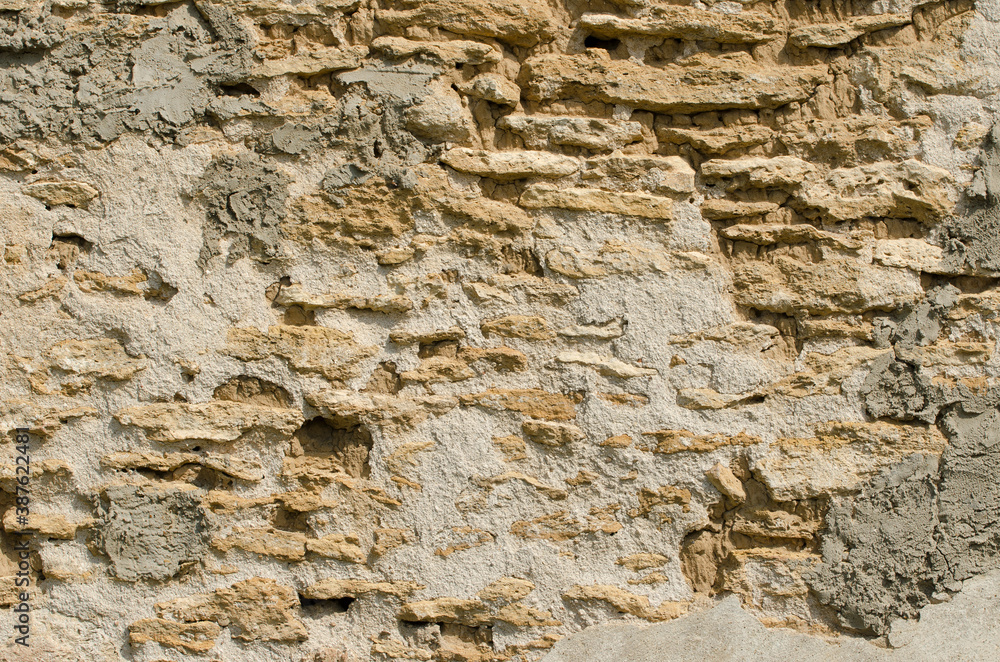 The texture of the old wall of natural stone.
