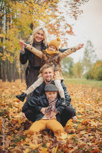 Family make people pyramid. leaf fall, lifestyle. Autumn season.