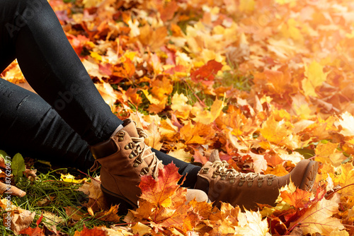 Woman hiker legs in autumn scenery. Young woman wearing boots.