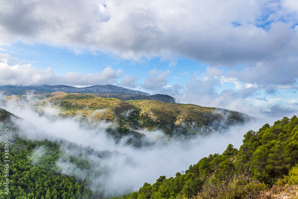 Obraz premium Confrides mountain´s port in the morning one day with low fog and clouds.