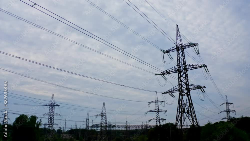 Silhouette of electric towers in the evening. High-voltage electric lines under the beautiful sky. Transmission lines. Many electrical pylons in nature. Silhouette of electric towers in the evening. High-voltage electric lines under the beautiful sky. Transmission lines. Many electrical pylons in nature.