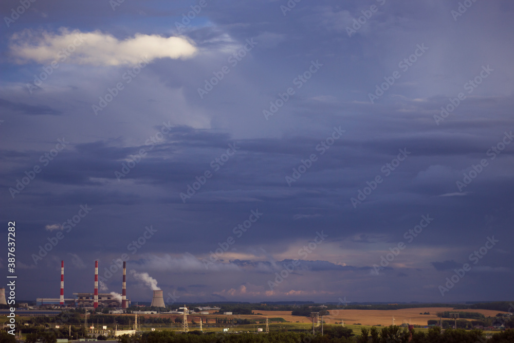 city industrial pipes with smog and dark sky 