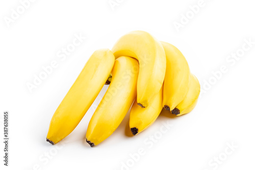 Shooting in the studio. A branch of ripe yellow bananas in a peel. On white background. Close-up. photo