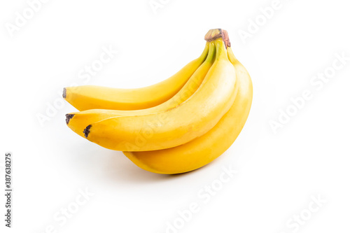 Shooting in the studio. A branch of ripe yellow bananas in a peel. On white background. Close-up.