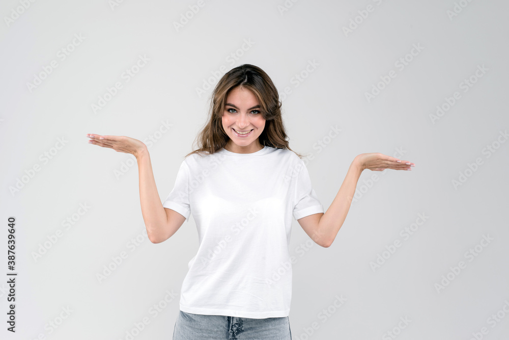 Woman confused and wondering shrugging with open palms. Beautiful lady standing and smiling and isolated on white background Woman confused and wondering shrugging with open palms. Beautiful lady standing and smiling and isolated on white background