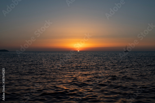 ship crosses the sea in the sunset