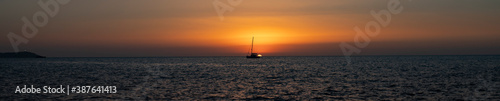 ship crosses the sea in the sunset © Jennifer