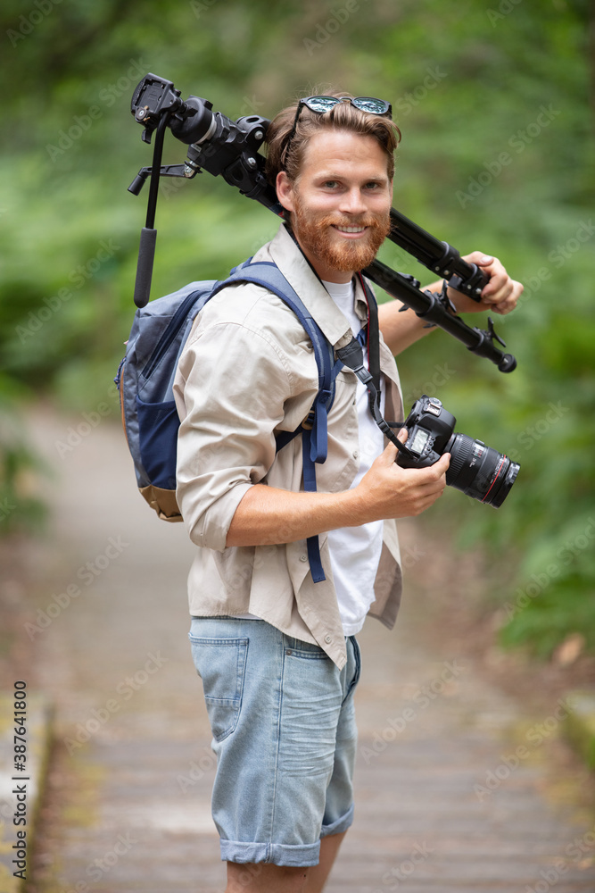 young professional traveler man with camera