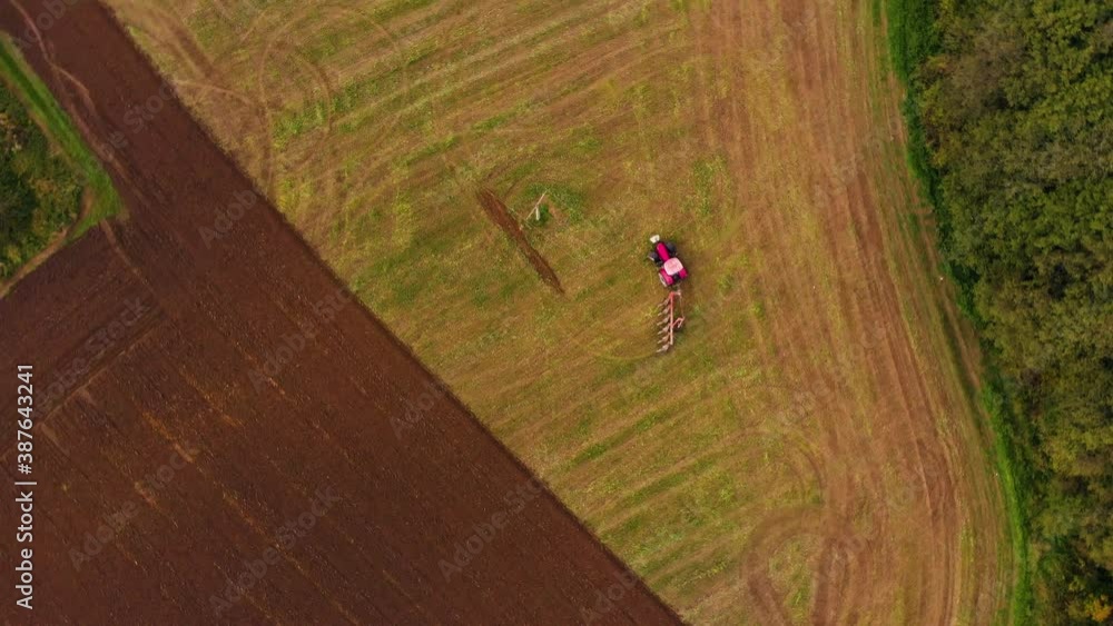 Tractor working one farm field drone view Tractor working one farm field drone view