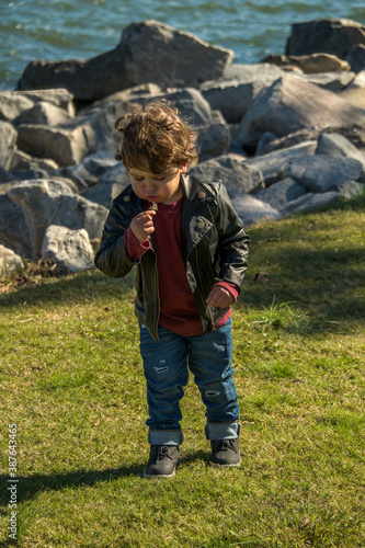Young Boy Blowing on Dandelion