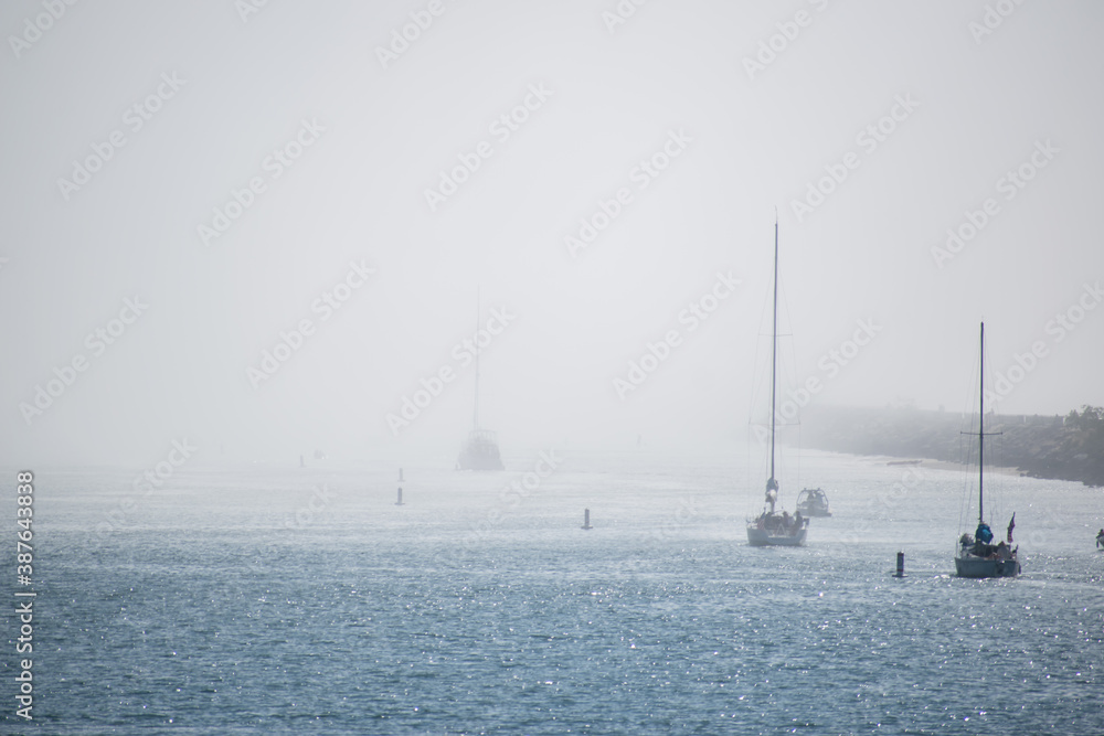 Boats head to sea in heavy fog in Marina del Rey Boats head to sea in heavy fog in Marina del Rey