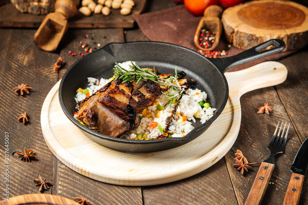 Mutton ribs with vegetables rice in cast iron pan Mutton ribs with vegetables rice in cast iron pan