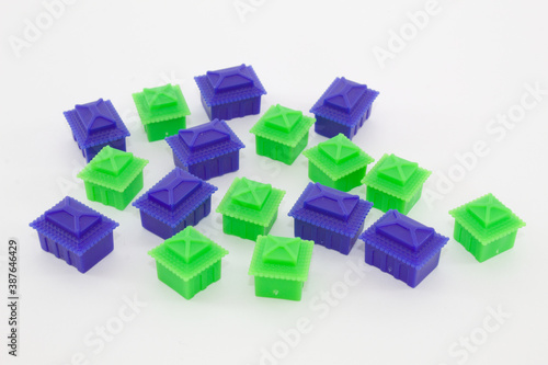 Green and blue house-shaped pieces for board games