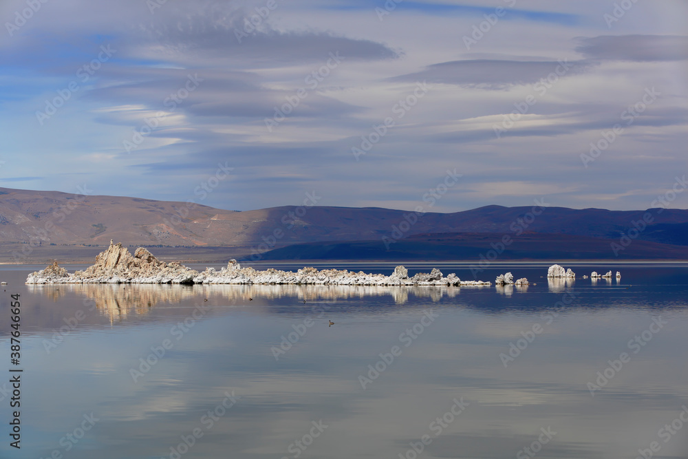 Mono Lake Tufa State Natural Reserve, California. Spectacular panoramic view with beautiful clouds and white tufa rocks in water.