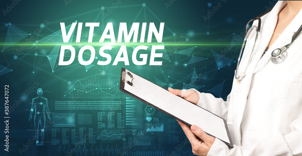 doctor writes notes on the clipboard with VITAMIN DOSAGE inscription, medical diagnosis concept doctor writes notes on the clipboard with VITAMIN DOSAGE inscription, medical diagnosis concept