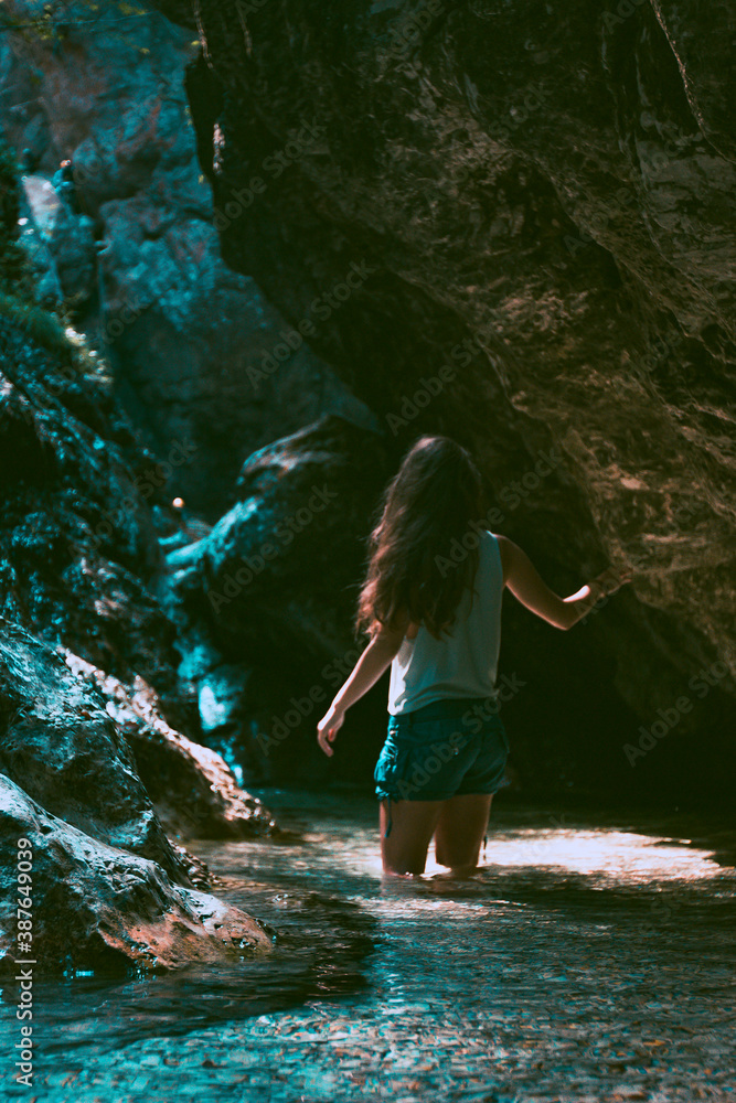 Young brunette woman discovering a steep rocky river canyon in Slovenia Young brunette woman discovering a steep rocky river canyon in Slovenia