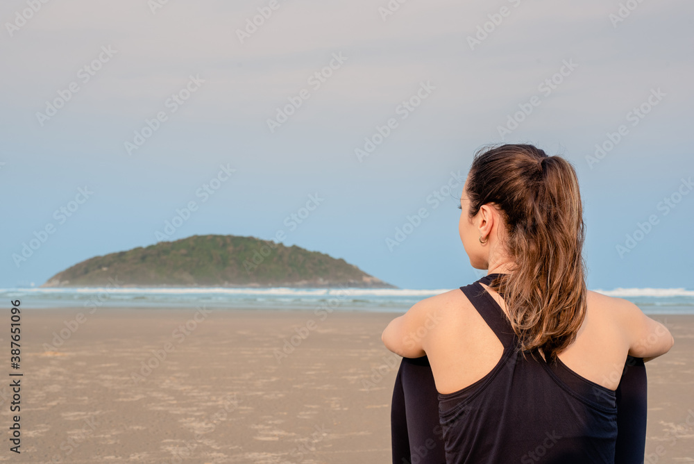 woman resting after running on the beach