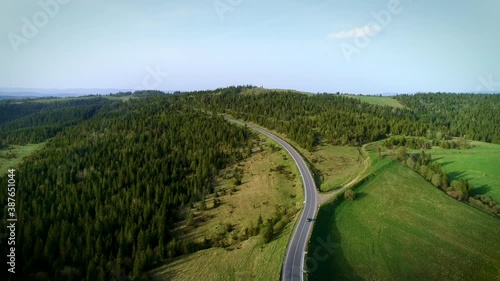 Mountain road. Spring. Route no H13 Ukraine. Coniferous forest in Europe. 
Aerial view of evening sunset. Travel on vacation photo